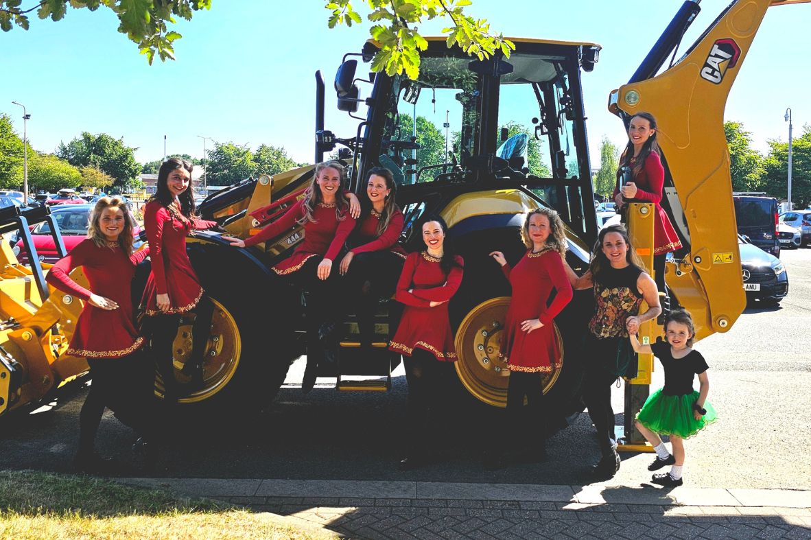 Elite Irish Dance performers with live Irish musicians during a stage show